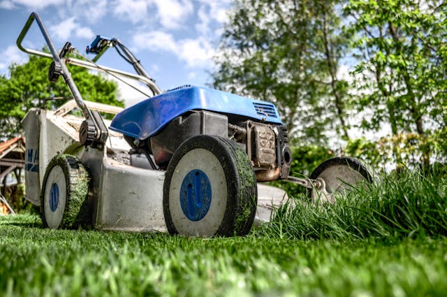 a blue lawn mower cutting grass